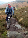 Chris attempts to ride over the big rock...