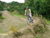 Oz rides berm, note the scuff mark in the soil near his front wheel, Chris's exit point.