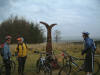 Some people pretending to be cyclists next to the National Cycle Route marker post