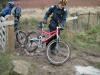 Simon sinking into the mud under the weight of sandwiches in his pack